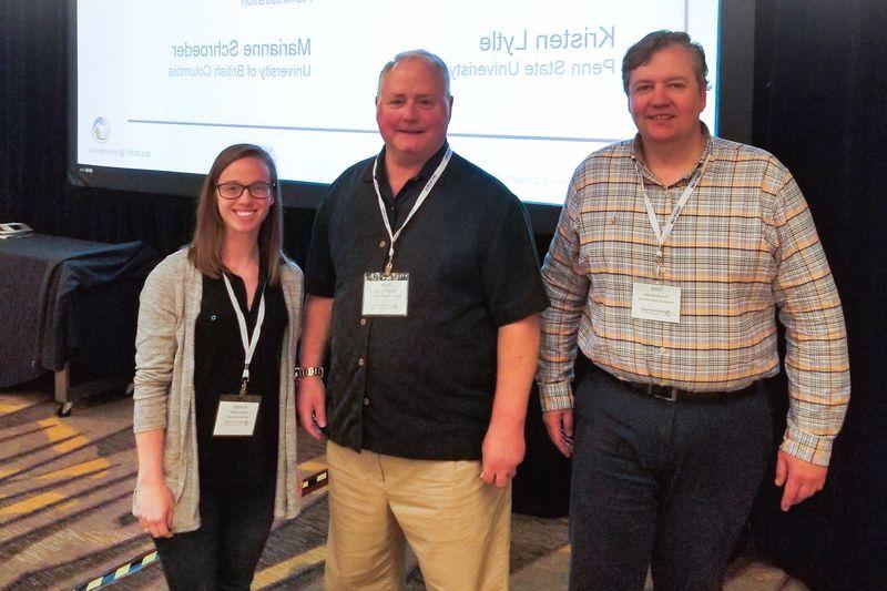 Penn State TLT Operations Team Award winners standing in front of a screen 