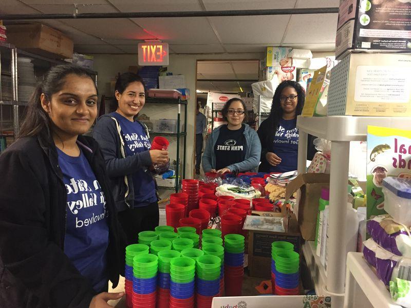 Group of volunteers stocking shelves