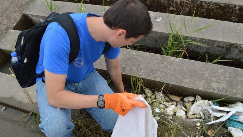 A man picks up trash