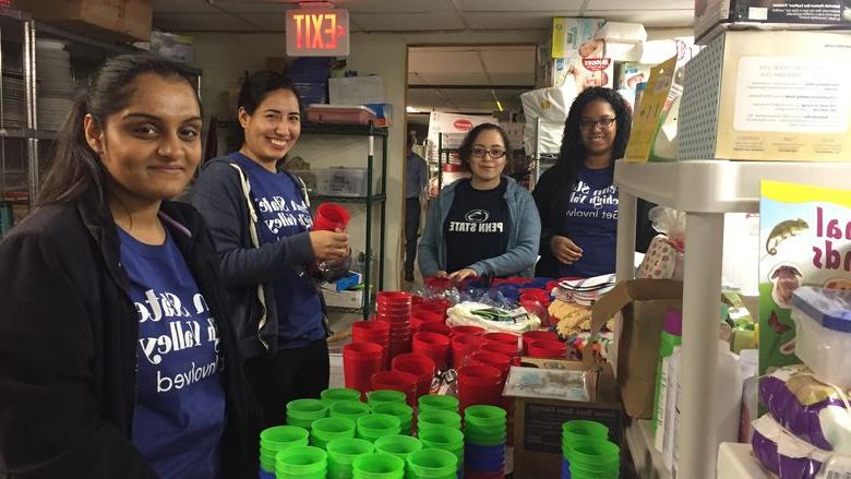 Group of volunteers stocking shelves