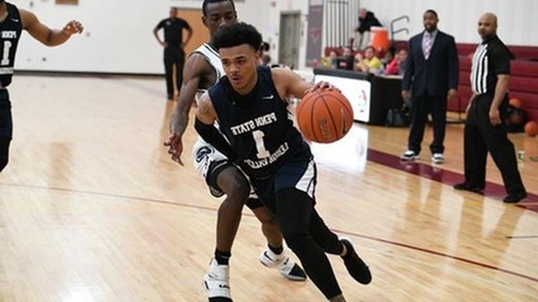 man dribbling down court